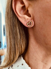 Učitaj sliku u preglednik galerije, Gold crystal heart stud earrings worn with casual outfit demonstrating lightweight everyday jewelry style
