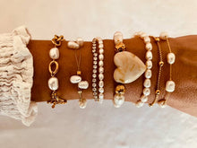 Load image into Gallery viewer, Pearl bracelet layered with other jewelry showing elegant stacking style
