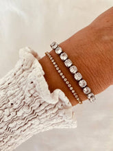 Load image into Gallery viewer, Gold tennis bracelet styled with outfit highlighting versatile luxury jewelry appeal
