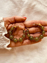 Učitaj sliku u preglednik galerije, Close-up of shimmering green resin beads showing reflective glossy finish and premium handmade jewelry design
