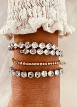 Load image into Gallery viewer, Gold tennis bracelet styled with casual outfit highlighting versatile luxury jewelry
