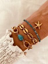 Load image into Gallery viewer, Shell bracelet styled with casual outfit highlighting versatile modern jewelry
