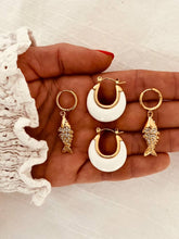 Učitaj sliku u preglednik galerije, Close-up of white hoop earrings highlighting minimalist design and refined modern style
