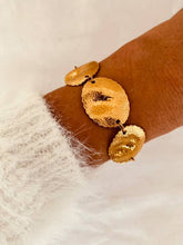 Load image into Gallery viewer, GILIAM gold statement bracelet with textured organic discs.

