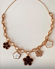 Učitaj sliku u preglednik galerije, Close-up of the HADDIE gold flower necklace highlighting the oversized enamel flower charms and polished gold links for timeless feminine styling.
