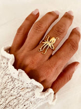 Load image into Gallery viewer, Gold plated stainless steel octopus ring worn on a woman's hand
