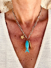 Load image into Gallery viewer, Elegant ocean-inspired layered necklace worn around the neck with turquoise fish pendant and textured starfish charm.
