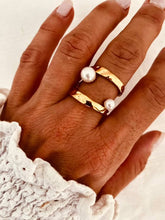 Load image into Gallery viewer, Gold plated stainless steel open ring featuring two elegant pearl accents worn on a woman's hand
