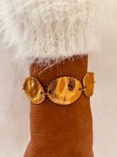 Load image into Gallery viewer, Modern textured gold bracelet worn on the wrist.
