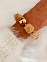 Load image into Gallery viewer, Taupe Marble IZZA bracelet styled on the wrist with elegant neutral marbled resin beads and polished gold details.
