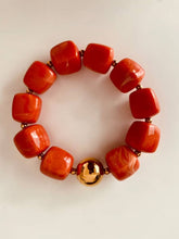 Load image into Gallery viewer, IZZA Coral Marble bracelet featuring vibrant coral marbled resin beads with a polished gold statement bead.
