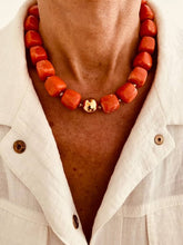 Load image into Gallery viewer, IZZA Coral Marble necklace worn on the model, adding vibrant colour and a modern statement to a white linen outfit.
