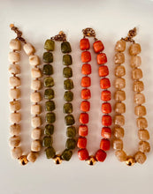 Load image into Gallery viewer, Flat lay of the IZZA Marble necklace collection featuring Cream Marble, Taupe Marble, Olive Marble and Coral Marble colour options.

