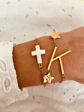 Load image into Gallery viewer, Gold initial bracelet layered with other bracelets showing trendy stacking style
