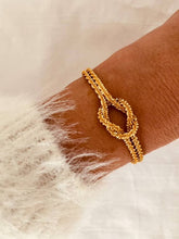 Load image into Gallery viewer, Knot chain cuff bracelet in gold plated stainless steel shown from front angle highlighting elegant minimalist jewelry design
