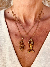 Load image into Gallery viewer, Cortie fish pendant necklace styled with other Bernat Jewelry pieces, inspired by the beauty and freedom of the sea.
