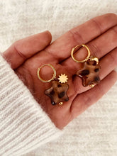 Load image into Gallery viewer, Leopard print star drop earrings with asymmetric moon and sun design shown from front angle highlighting bold statement jewelry style
