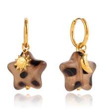 Load image into Gallery viewer, Acrylic star earrings with leopard print pattern highlighting lightweight comfortable design and gold plated accents
