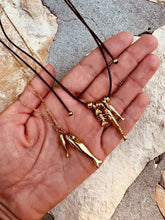 Load image into Gallery viewer, Gold necklace with one large and one small fish pendant.
