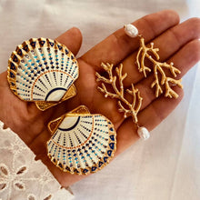Učitaj sliku u preglednik galerije, White shell earrings with blue enamel and gold details.
