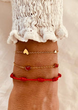Load image into Gallery viewer, Three heart bracelet styled with outfit demonstrating soft feminine everyday jewelry style
