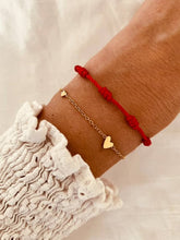 Load image into Gallery viewer, Side angle of red rope bracelet showing structure and braided detail
