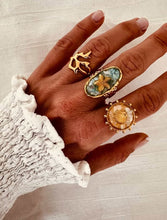 Load image into Gallery viewer, Abstract gold ring styled on hand demonstrating elegant everyday jewelry style
