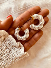 Učitaj sliku u preglednik galerije, Geometric pearl earrings displayed on neutral background highlighting clean modern jewelry aesthetic
