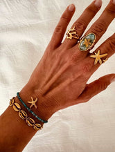 Load image into Gallery viewer, Abstract ring worn as subtle statement jewelry highlighting minimalist fashion style
