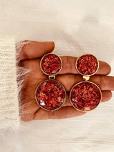 Load image into Gallery viewer, Pair of NYOKO red resin drop earrings photographed on a white background, highlighting the round statement design.
