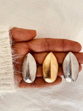 Load image into Gallery viewer, Modern leaf earrings available in gold and silver.
