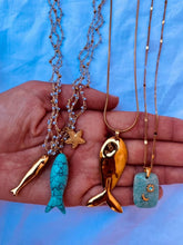 Load image into Gallery viewer, Layered gold fish necklace paired with elegant summer necklaces for a sophisticated everyday look.

