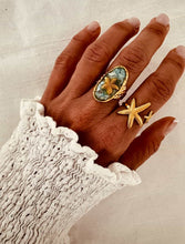 Load image into Gallery viewer, Starfish turquoise ring styled on hand demonstrating elegant summer jewelry style
