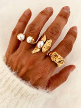 Load image into Gallery viewer, Modern AFON gold statement ring with genuine freshwater pearl photographed alongside coordinating pearl rings to create an elegant layered jewelry look.
