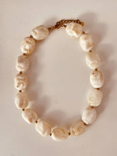 Load image into Gallery viewer, Elegant ivory necklace with gold-plated accents.
