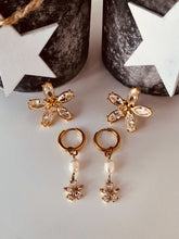 Učitaj sliku u preglednik galerije, Flower tassel earrings displayed on neutral background showcasing refined feminine jewelry aesthetic
