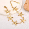 Gold plated stainless steel starfish bracelet displayed from front angle highlighting ocean inspired elegant jewelry design