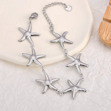 Load image into Gallery viewer, Silver plated stainless steel starfish bracelet displayed from front angle highlighting ocean inspired elegant jewelry design
