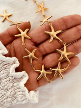 Load image into Gallery viewer, Bold gold starfish necklace displayed from front highlighting statement jewelry design
