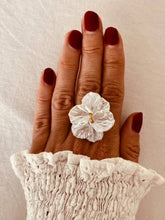 Load image into Gallery viewer, White floral ring worn on a model.

