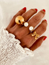 Load image into Gallery viewer, Elegant gold pearl ring close-up on hand, luxury adjustable pearl jewelry for women

