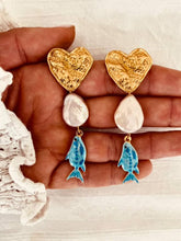 Load image into Gallery viewer, Anderson statement earrings featuring textured gold hearts, freshwater pearls and blue fish charms inspired by Mediterranean coastal style
