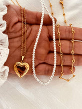 Load image into Gallery viewer, Detailed view of carved heart medallion pendant in 18K gold plated stainless steel.
