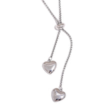 Load image into Gallery viewer, Silver tone stainless steel double heart necklace featuring adjustable chain and two heart pendants for a clean modern style
