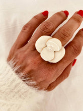 Load image into Gallery viewer, Galatia white enamel flower statement ring with oversized floral design and gold-plated finish worn on hand
