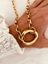 Load image into Gallery viewer, Gold chain necklace with a large, intricate clasp worn by a person 
