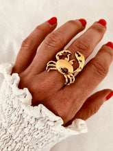 Load image into Gallery viewer, Hubertine crab statement ring featuring a detailed gold-plated crab design inspired by coastal living and ocean beauty worn on hand

