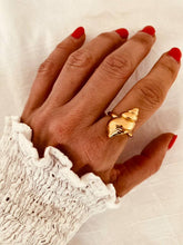 Load image into Gallery viewer, Khalia spiral shell statement ring with textured gold-plated finish worn on hand
