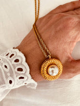 Load image into Gallery viewer, Gold plated stainless steel medallion necklace with detailed carved pendant and central stone displayed on a refined chain for an elegant statement look
