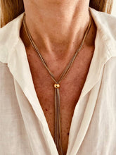 Load image into Gallery viewer, Minimalist outfit styled with long gold tassel necklace
